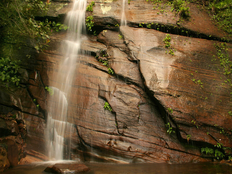 Waterfall on Rock Face — Brown