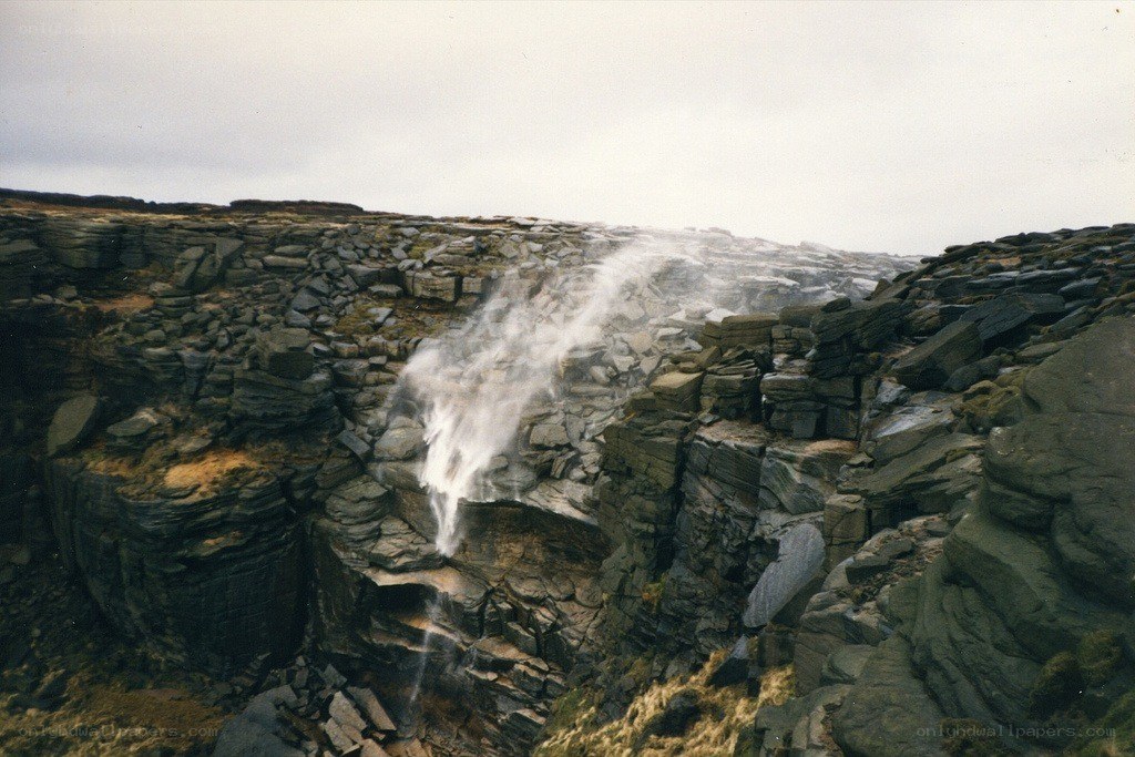 Waterfall on rocky cliff