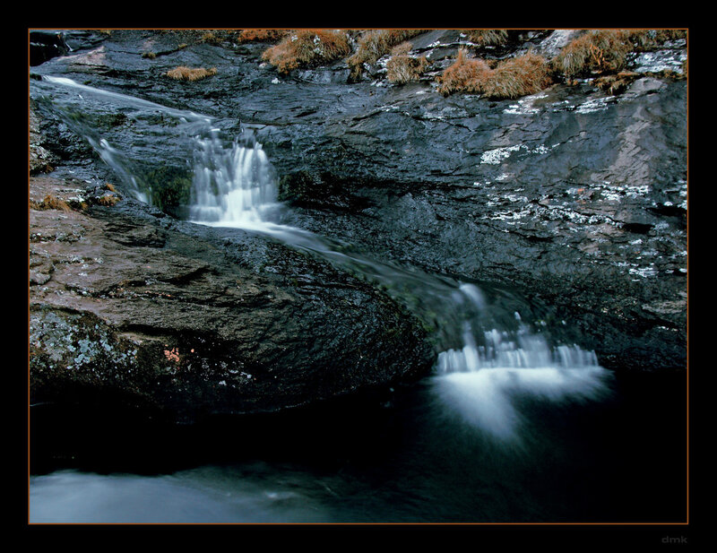 Waterfall on rocky cliff