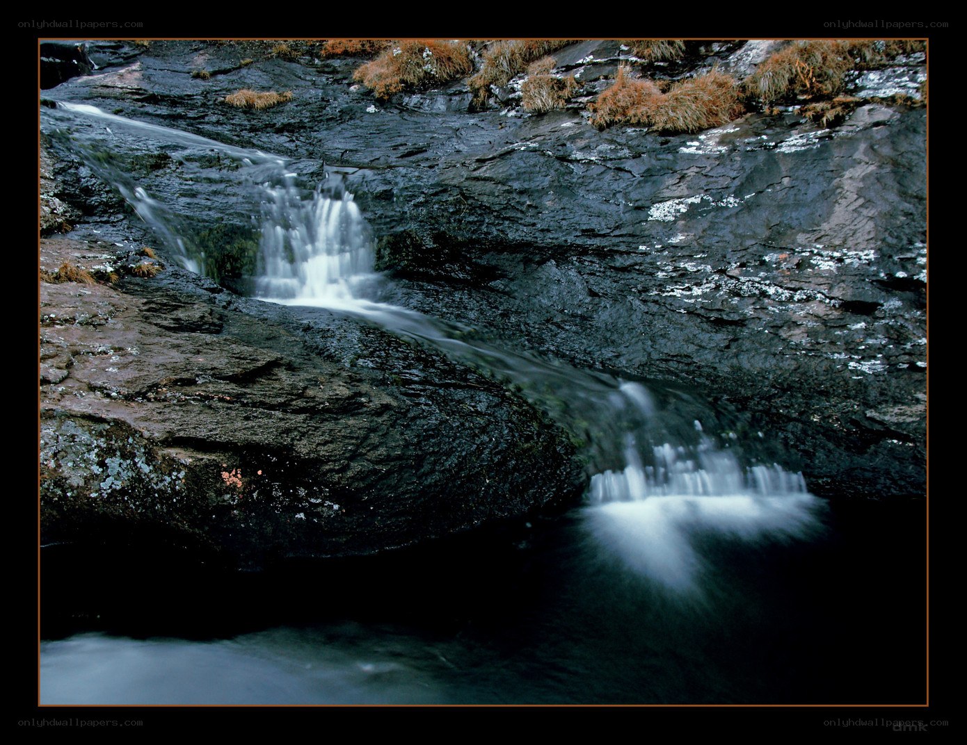 Waterfall on rocky cliff