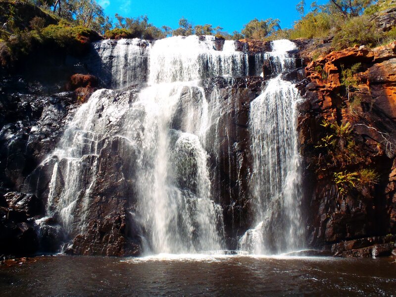 Waterfall on Rocky Cliff — Blue, Dramatic, Afternoon, Photograph, Rocks