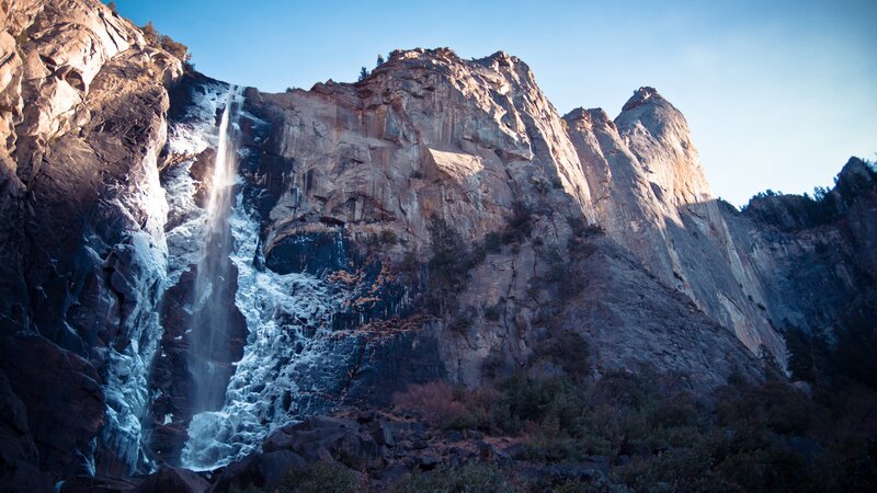 Waterfall on Rocky Cliff — Blue, Dramatic, Afternoon, Photograph