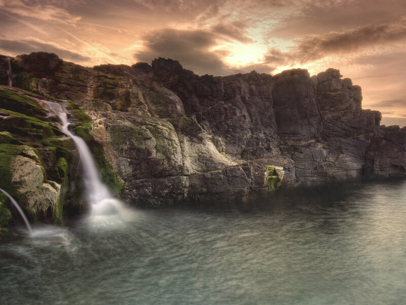 Waterfall on Rocky Cliff — Brown, Dramatic, Sunset