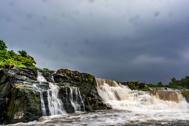 Waterfall on Rocky Cliff — Gray, Dramatic, Photograph, Rocks