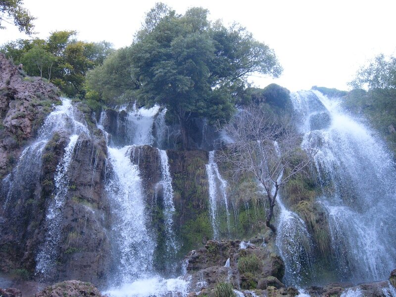 Waterfall on Rocky Cliff — Green, Natural, Photograph, Trees, Rocks