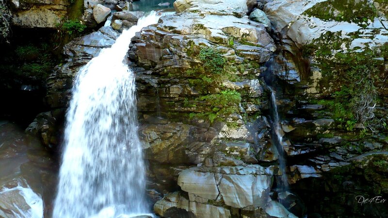 Waterfall on Rocky Cliff — Green, Serene, Afternoon, Photograph, Rocks, Moss