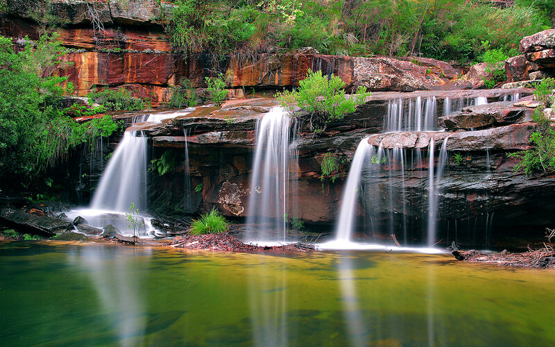 Waterfall on Rocky Cliff — Green, Serene, Afternoon, Photograph, Rocks, Trees, Pool