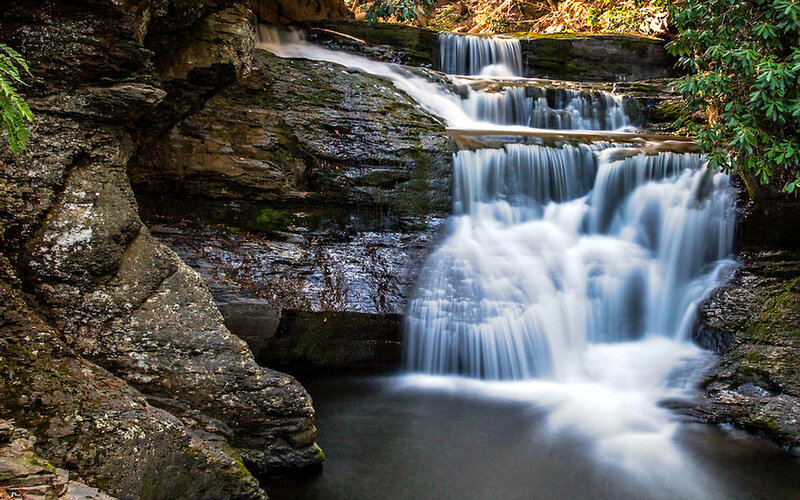 Waterfall on Rocky Cliff — Green, Serene, Afternoon, Photograph, Rocks, Trees