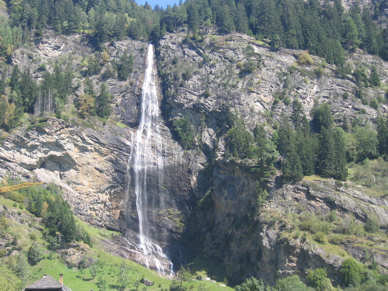 Waterfall on Rocky Cliff — Green, Serene, Afternoon, Photograph, Trees, Mountain