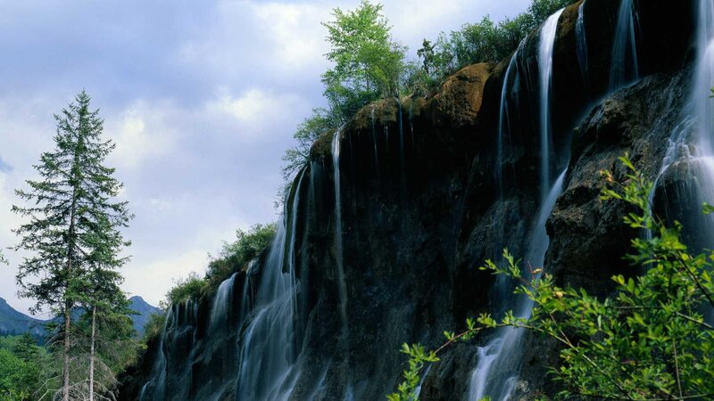 Waterfall on Rocky Cliff — Green, Serene, Afternoon, Photograph, Trees, Mountains