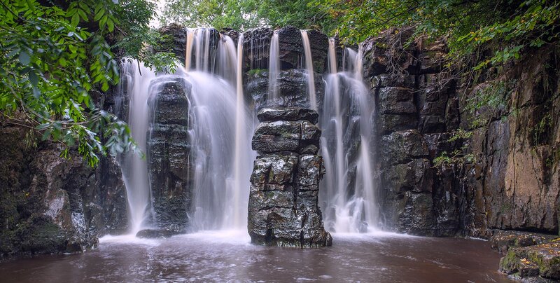 Waterfall on Rocky Cliff — Green, Serene, Afternoon, Photograph, Trees, Rocks, Pool