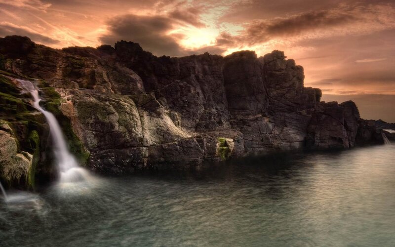Waterfall on Rocky Cliff — Orange, Dramatic, Sunset, Photograph