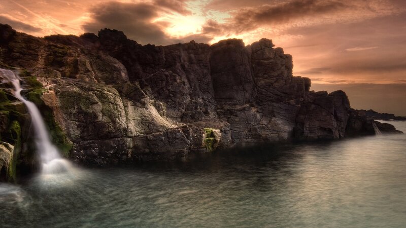 Waterfall on Rocky Cliff — Orange, Dramatic, Sunset