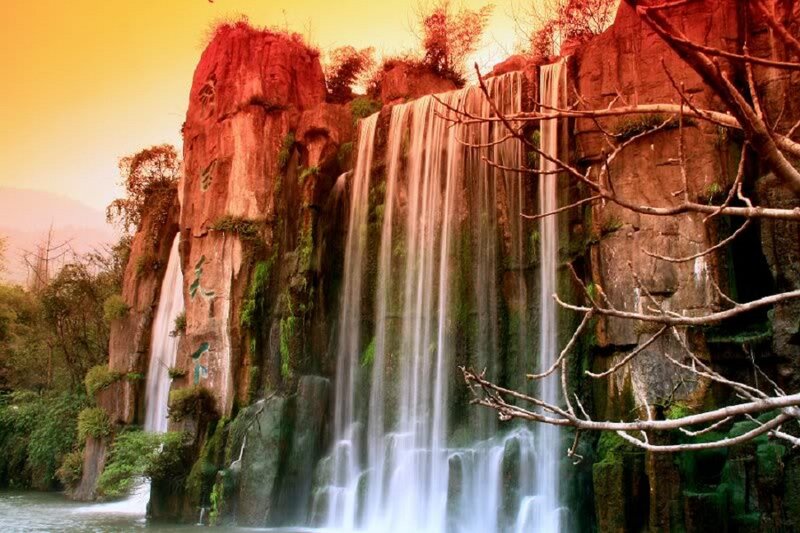 Waterfall on Rocky Cliff — Orange, Dramatic