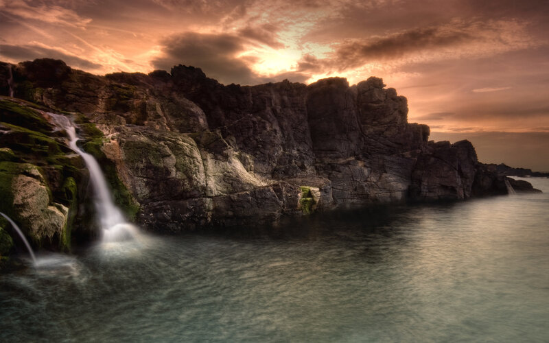 Waterfall on Rocky Cliff — Photograph