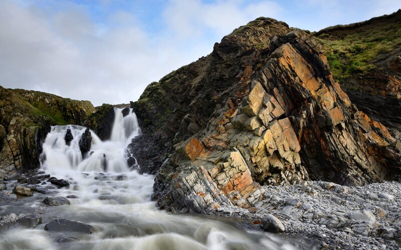 Waterfall on Rocky Coast — Gray, Dramatic