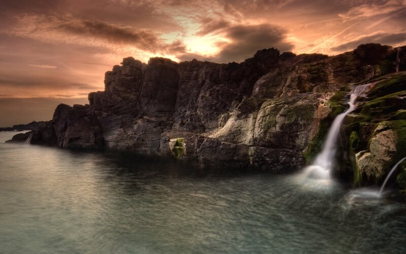 Waterfall on Rocky Coast — Orange, Dramatic, Sunset, Photograph, Cliffs