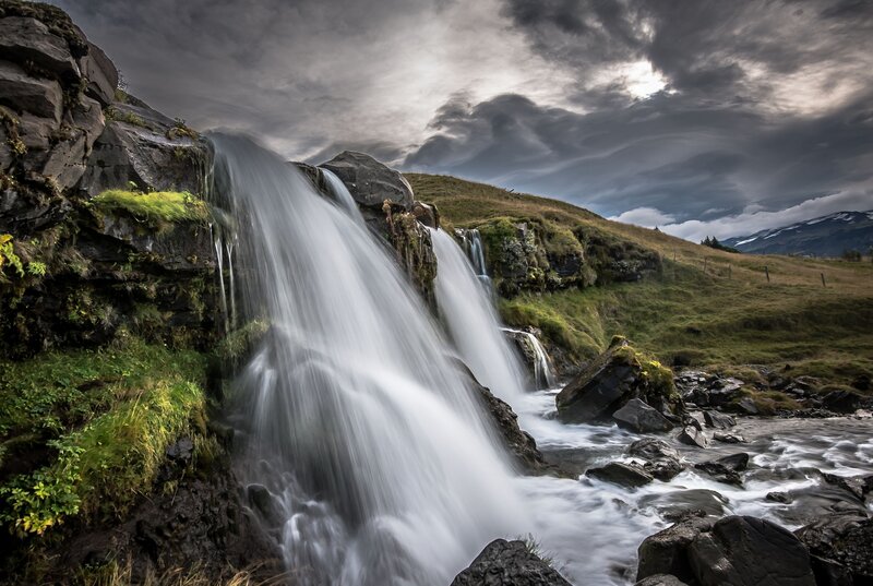 Waterfall on Rocky Hillside — Gray, Dramatic
