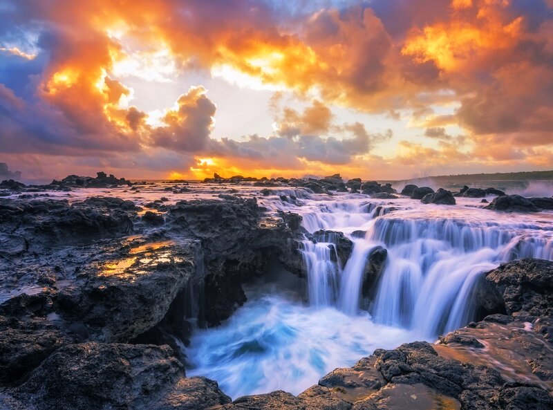 Waterfall on Rocky Shore — Orange, Dramatic