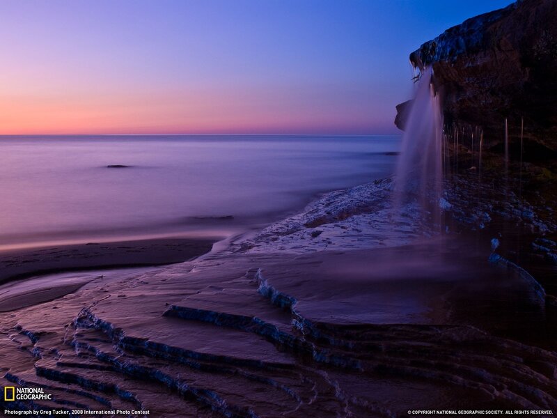 Waterfall on Rocky Shore — Purple, Serene, Sunset