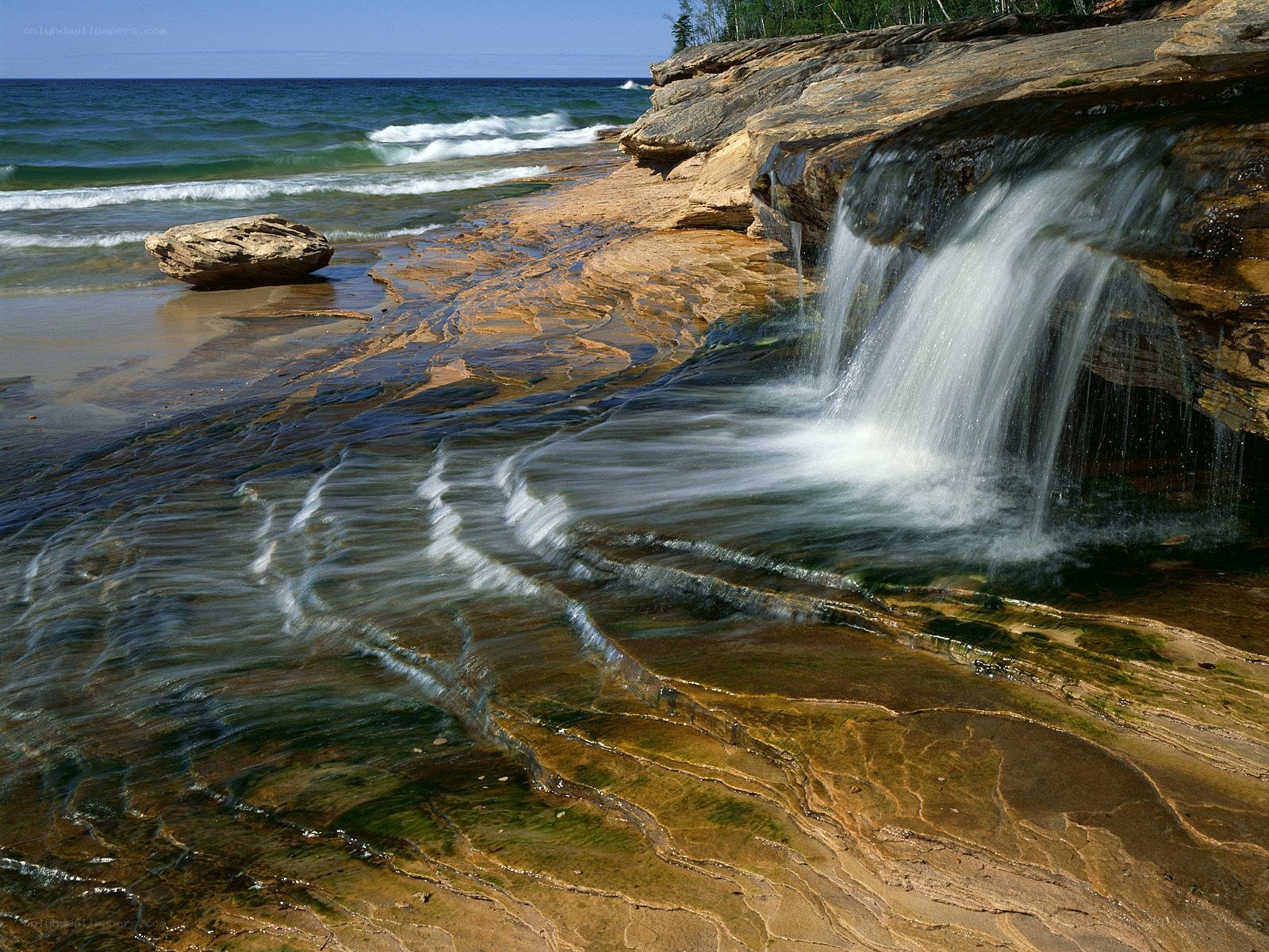 Waterfall on rocky shoreline