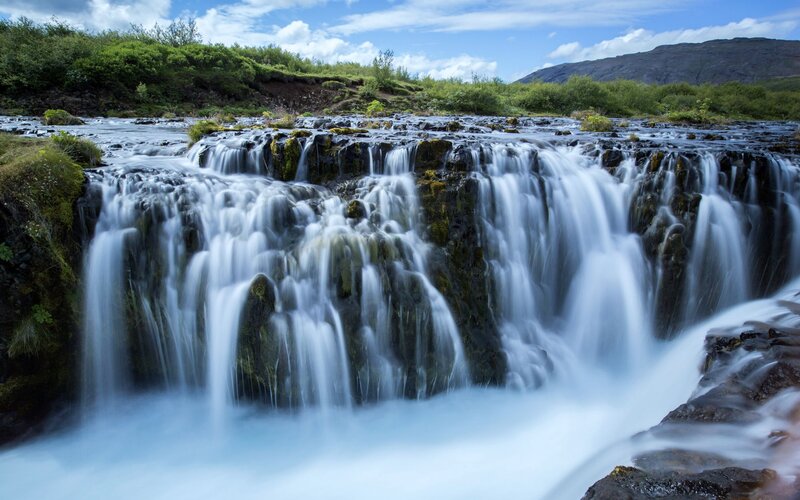 Waterfall on Rocky Terrain — Blue, Serene, Afternoon