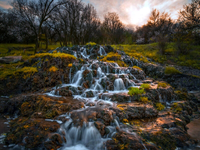 Waterfall on Rocky Terrain — Green, Serene