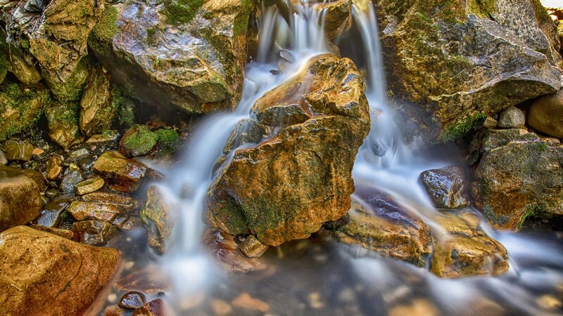 Waterfall over mossy rocks