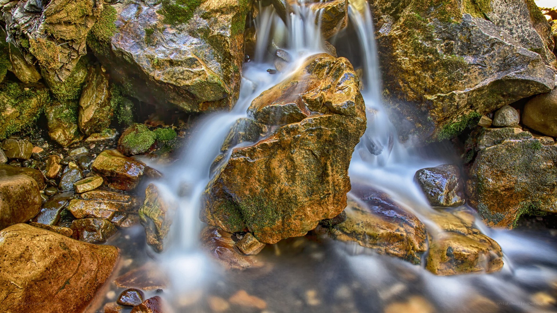 Waterfall over mossy rocks