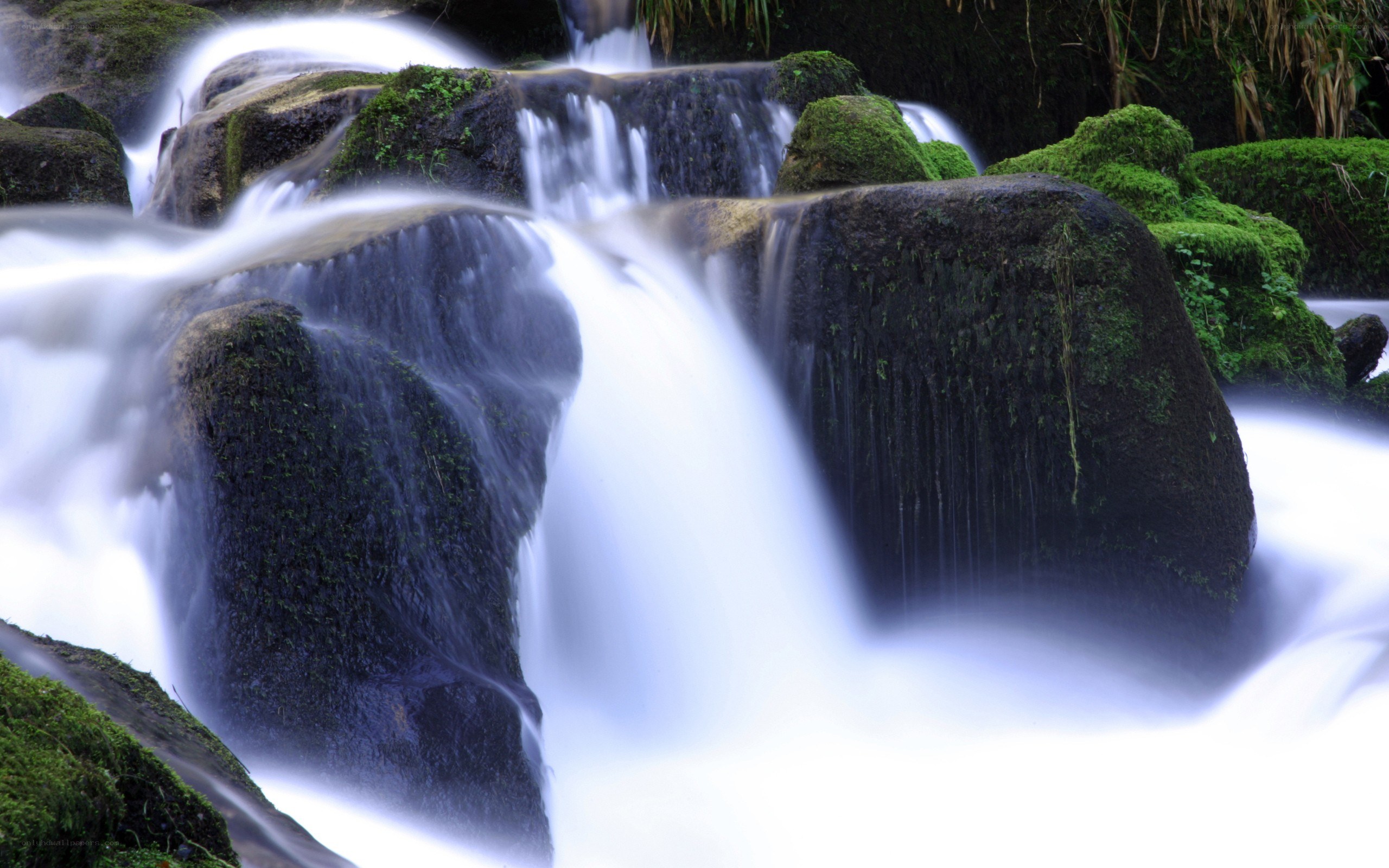 Waterfall over mossy rocks