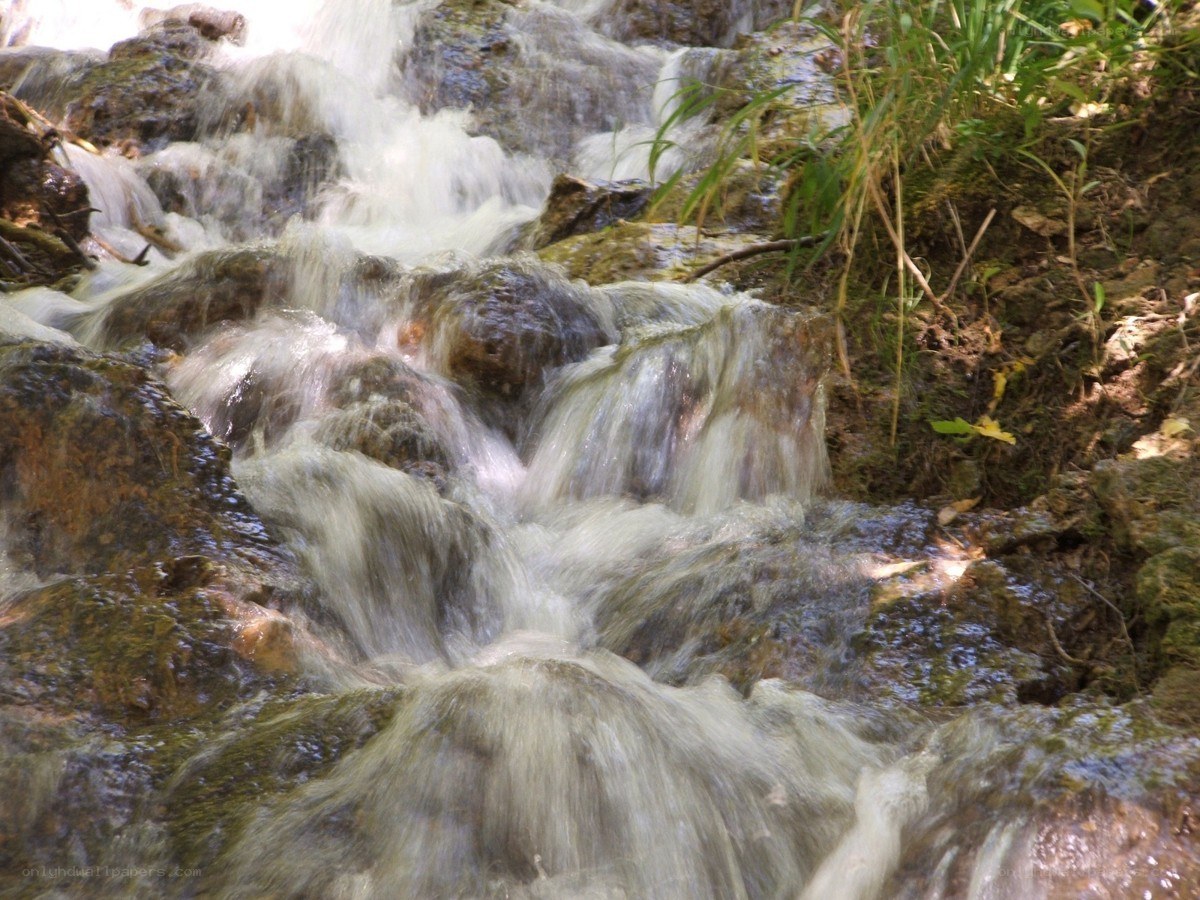 Waterfall over mossy rocks