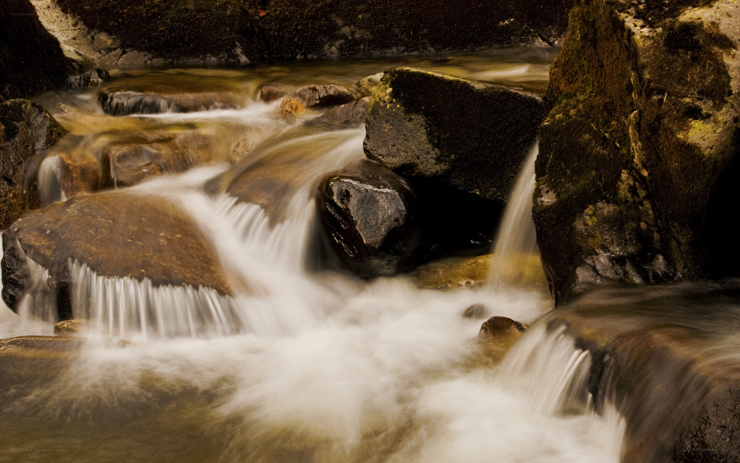 Waterfall over mossy rocks