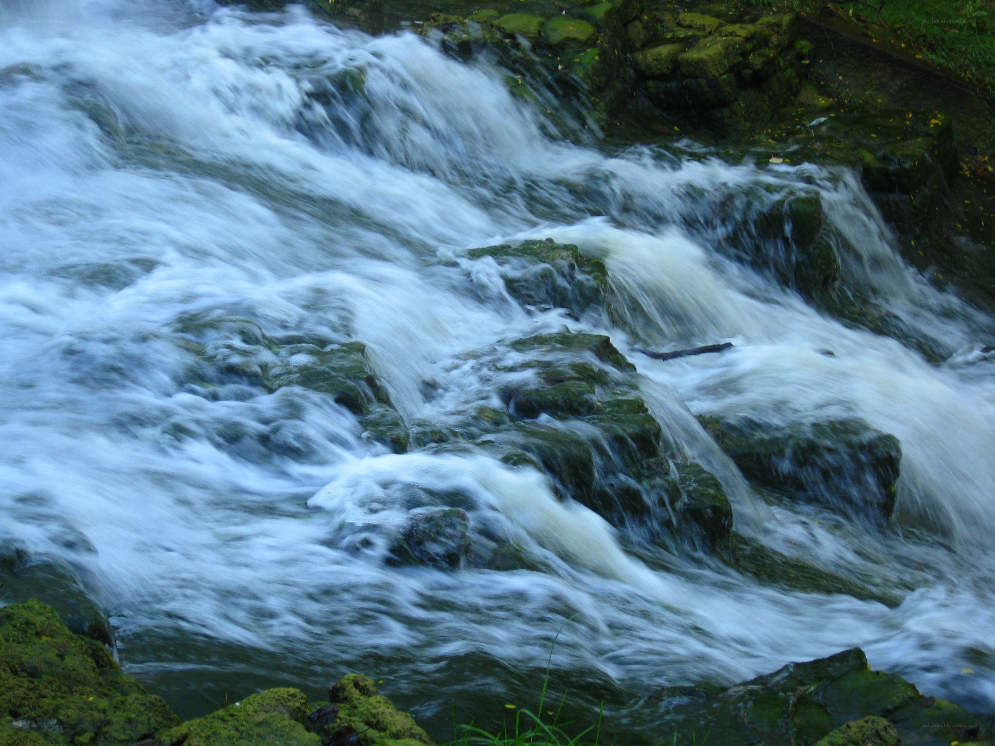 Waterfall over mossy rocks