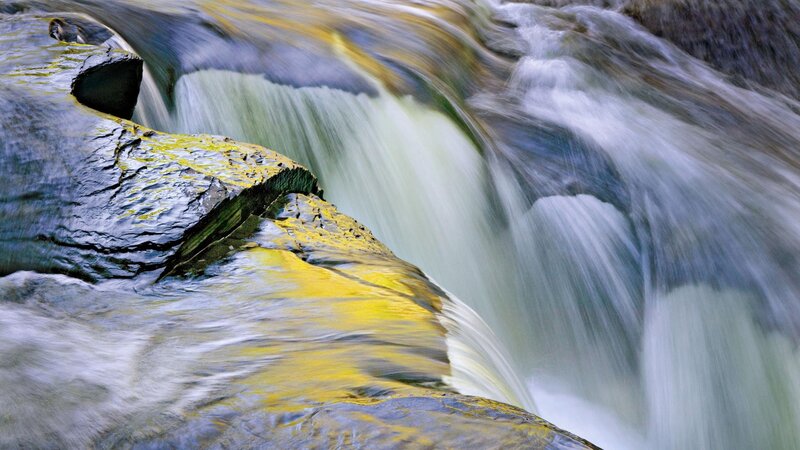 Waterfall over mossy rocks