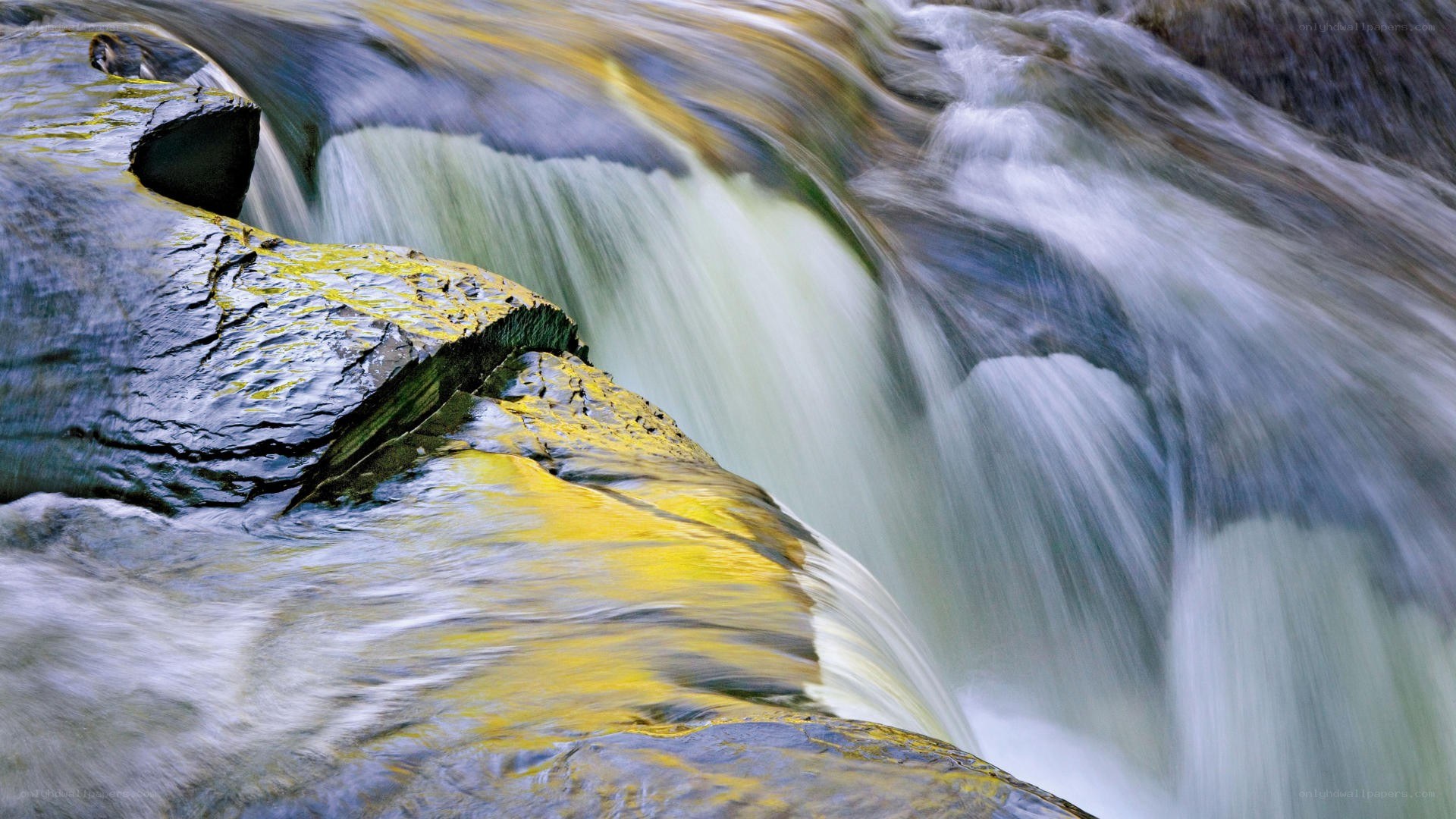 Waterfall over mossy rocks