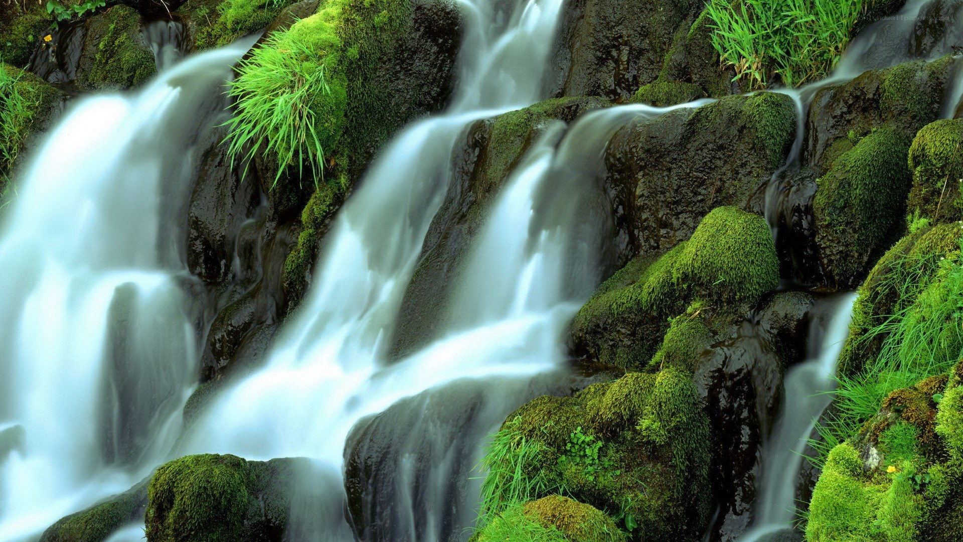 Waterfall over mossy rocks