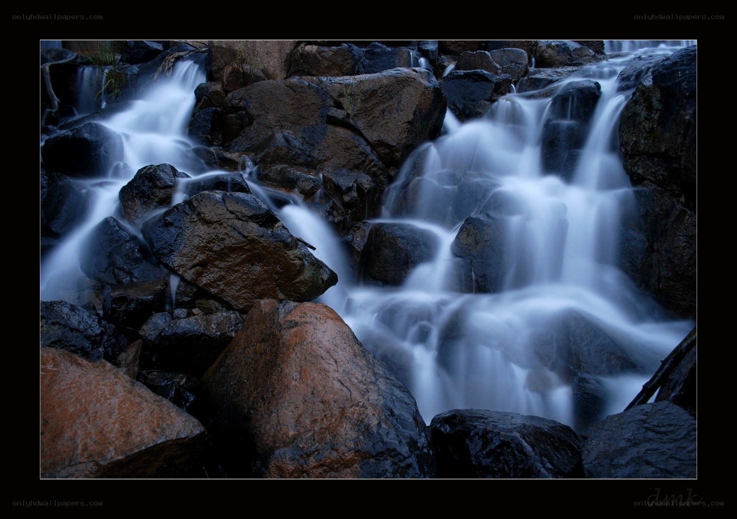 Waterfall over rocks at dusk