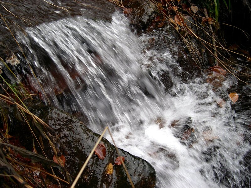 Waterfall over rocks in autumn