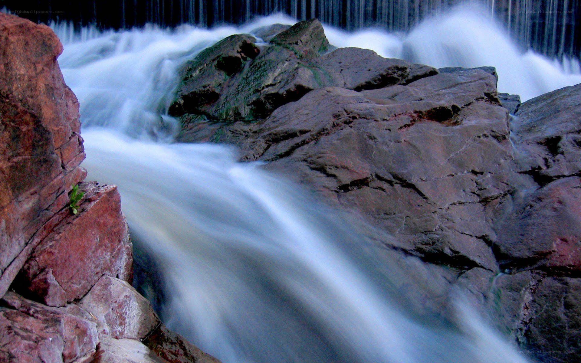 Waterfall over rocky terrain
