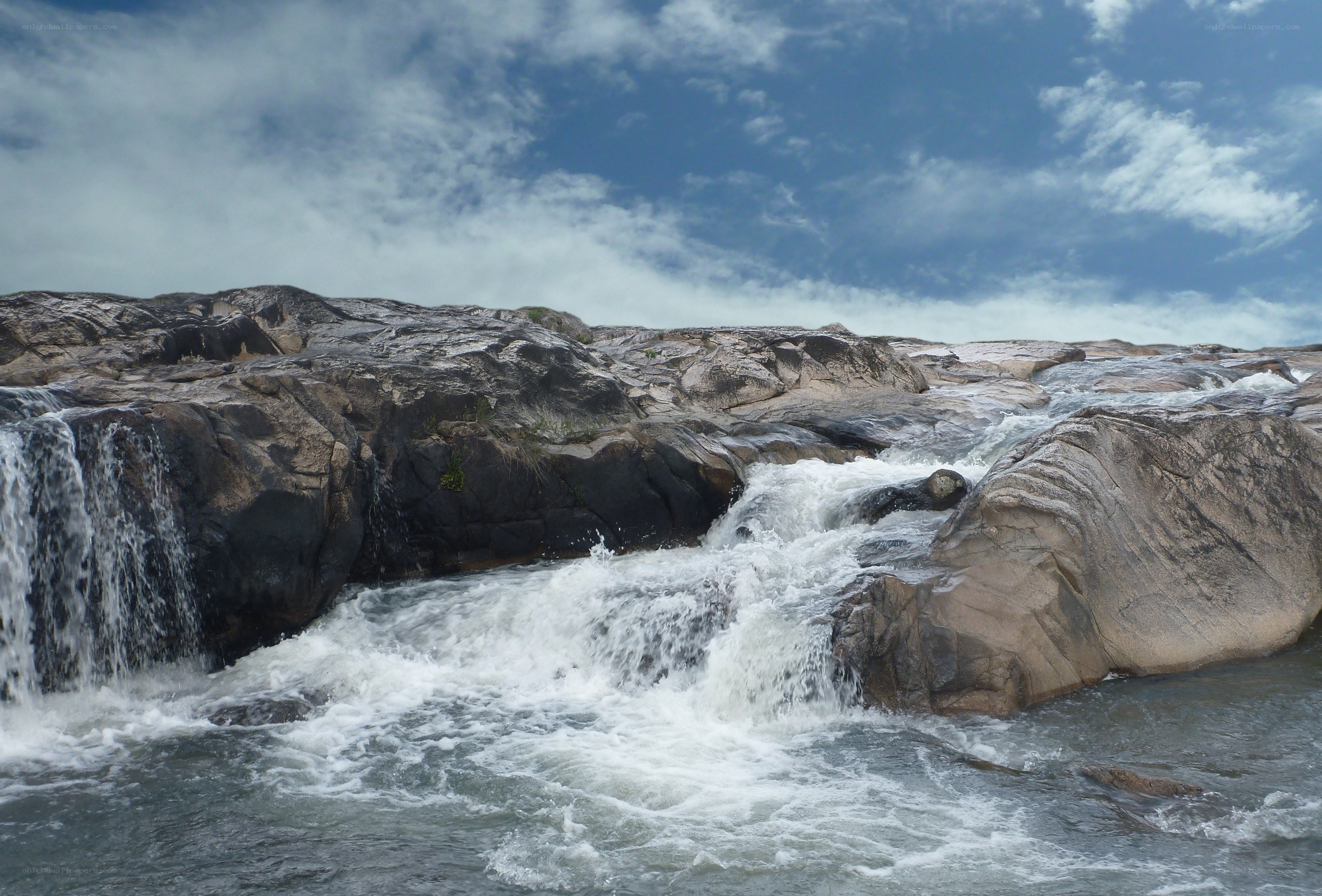 Waterfall over rocky terrain