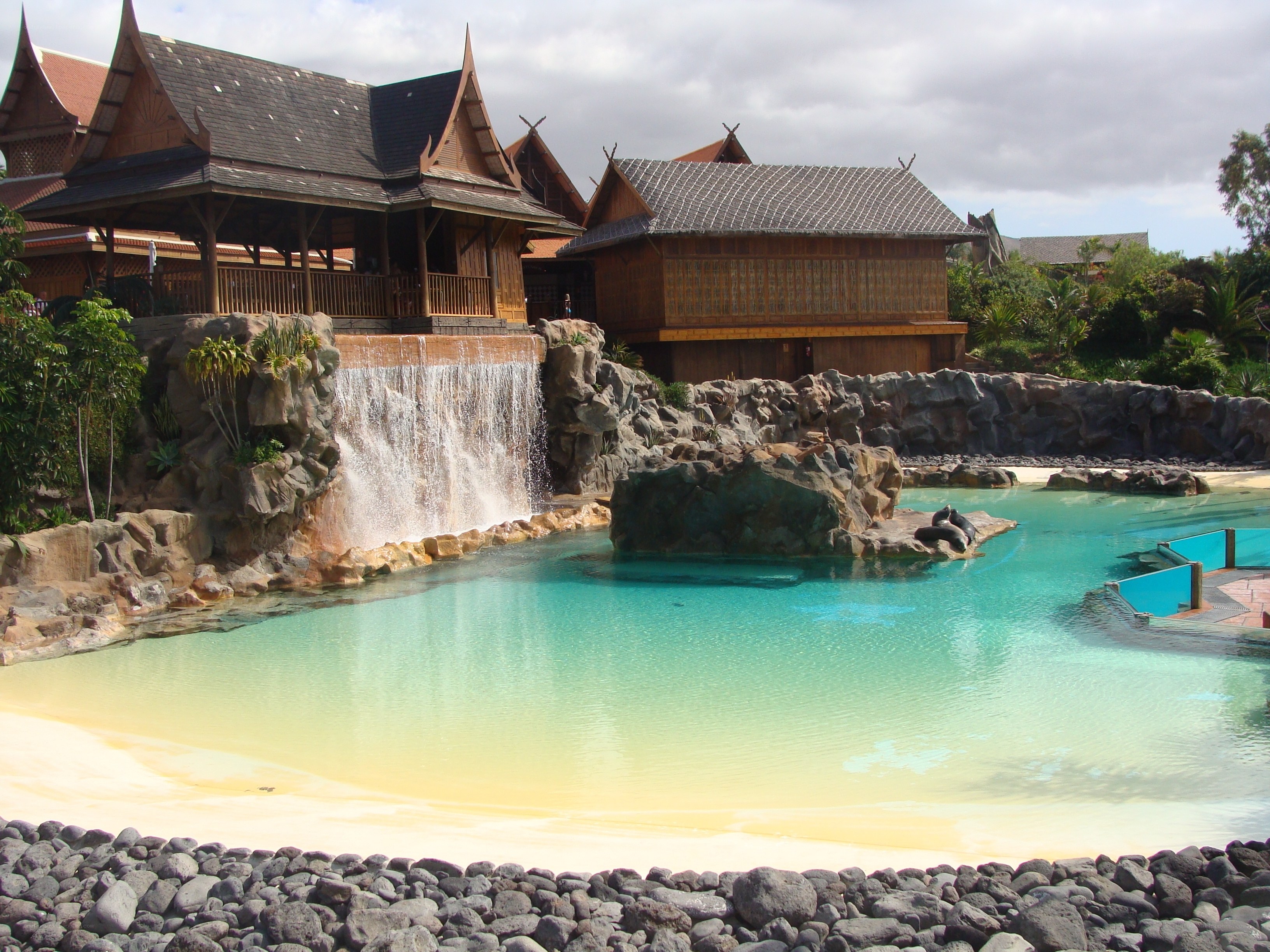 Waterfall pool with Thai-style buildings