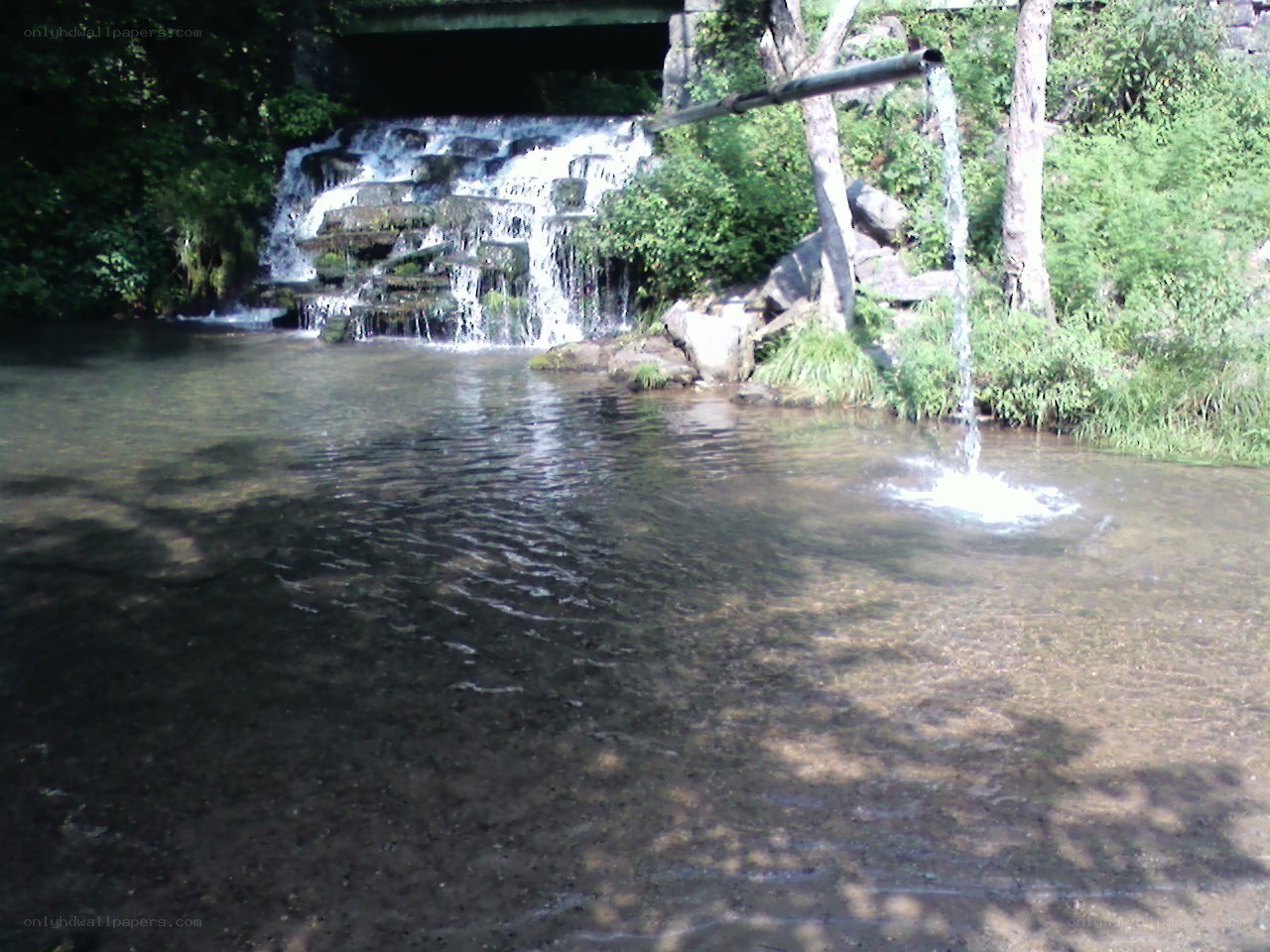 Waterfall under a bridge