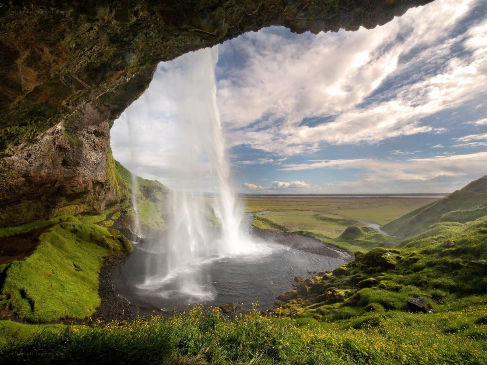 Waterfall under a cave in Iceland