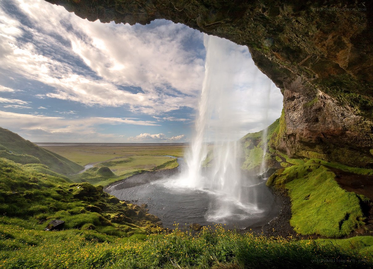 Waterfall under a cave in Iceland