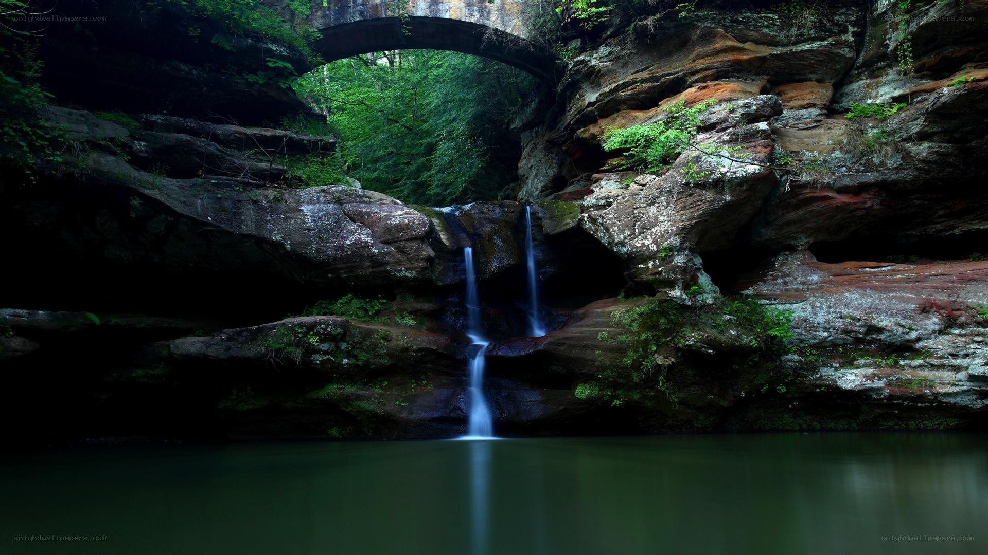 Waterfall under a natural bridge