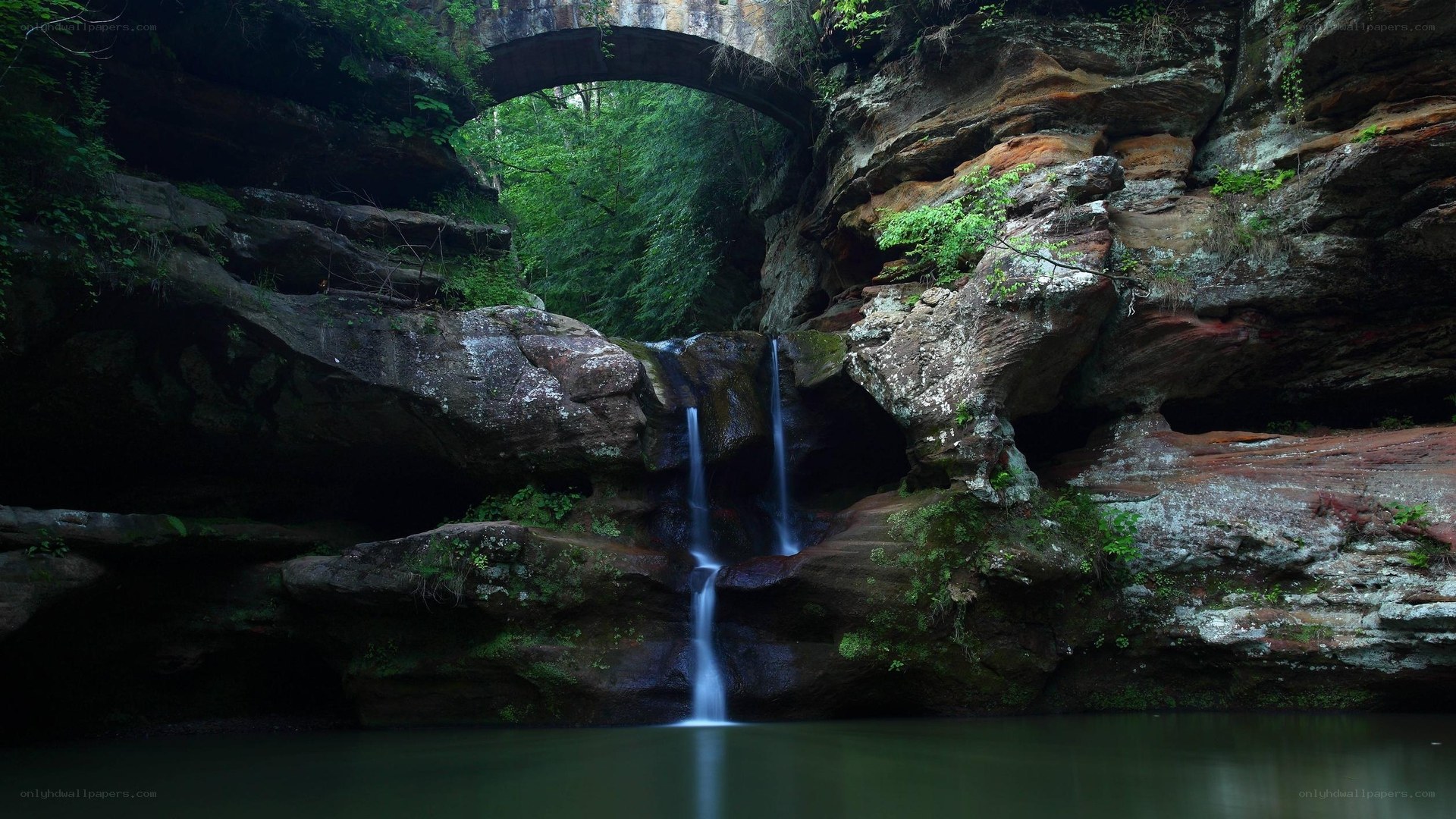 Waterfall under a natural bridge