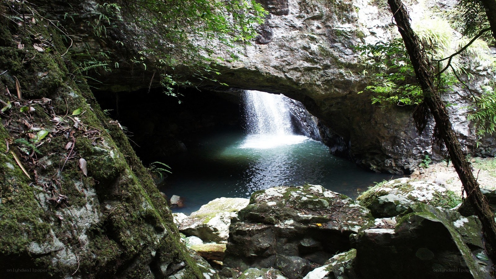 Waterfall under a natural rock arch