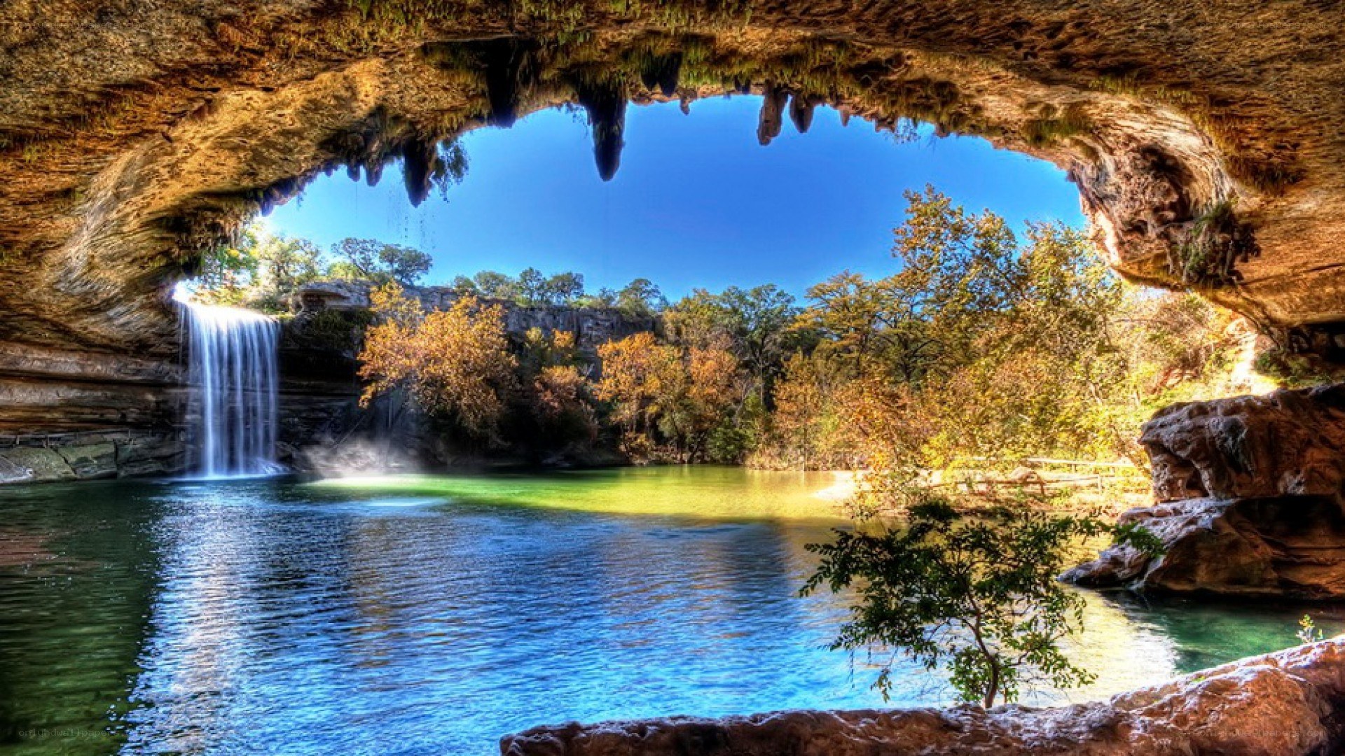 Waterfall under a natural rock arch