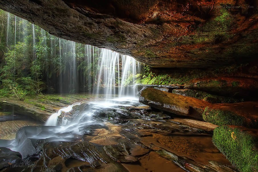 Waterfall under a rock overhang