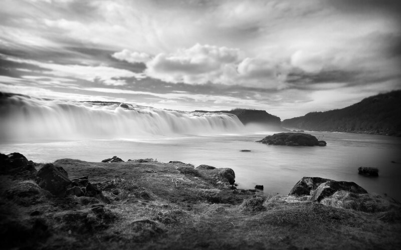 Waterfall under cloudy sky